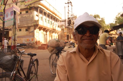 man in Varanasi with white hat and dark glasses